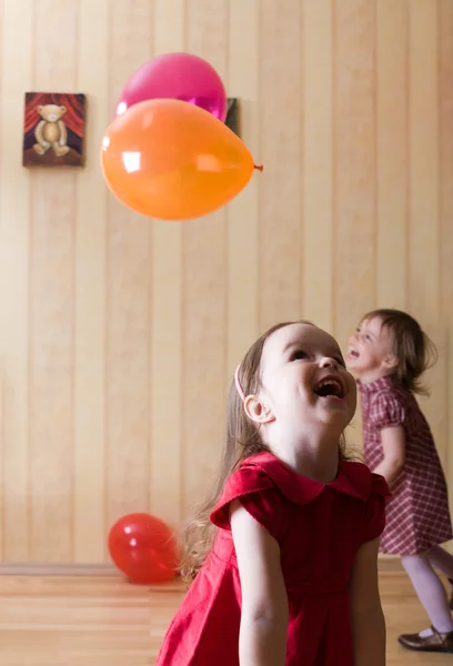Portrait of two little girls playing with airy balls — Stock Photo, Image