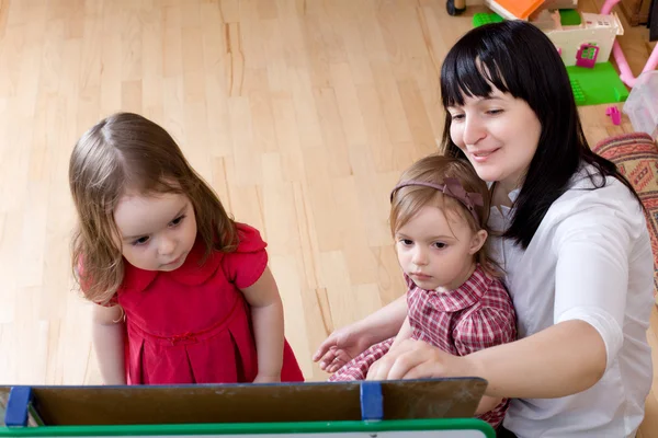 Vorbereitung auf Schulserien. Mutter lehrt ihre Töchter — Stockfoto