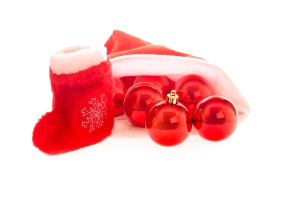 Santa hat and boot with red christmas balls — Stock Photo, Image