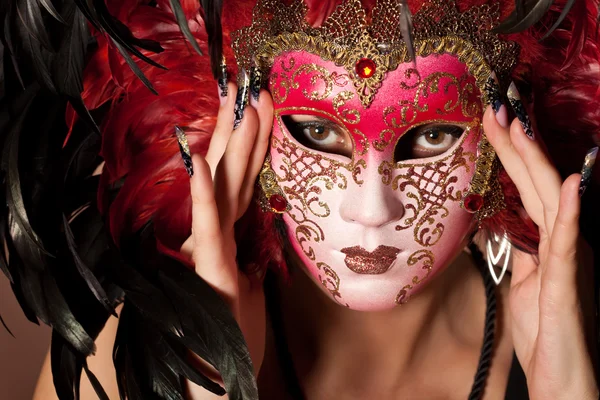 Woman with beautiful manicure on long finger hold venetian mask — Stock Photo, Image