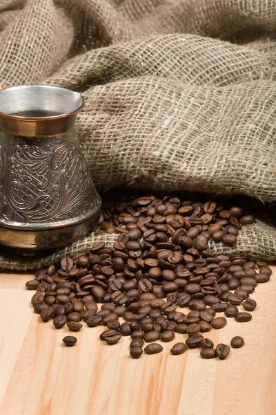 Cezve 与新鲜烘培咖啡豆在桌子上 图库照片