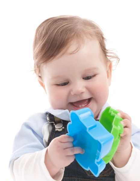 Porträt eines entzückenden glücklichen blauäugigen Jungen, der mit Spielzeug spielt Stockbild