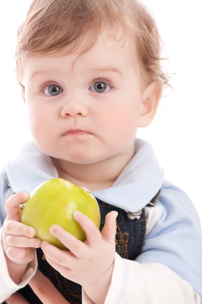 Portrait of adorable blue-eyes baby hold green apple Royalty Free Stock Images