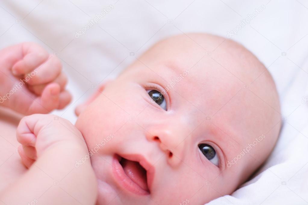 Little baby dream. Head with arms close-up