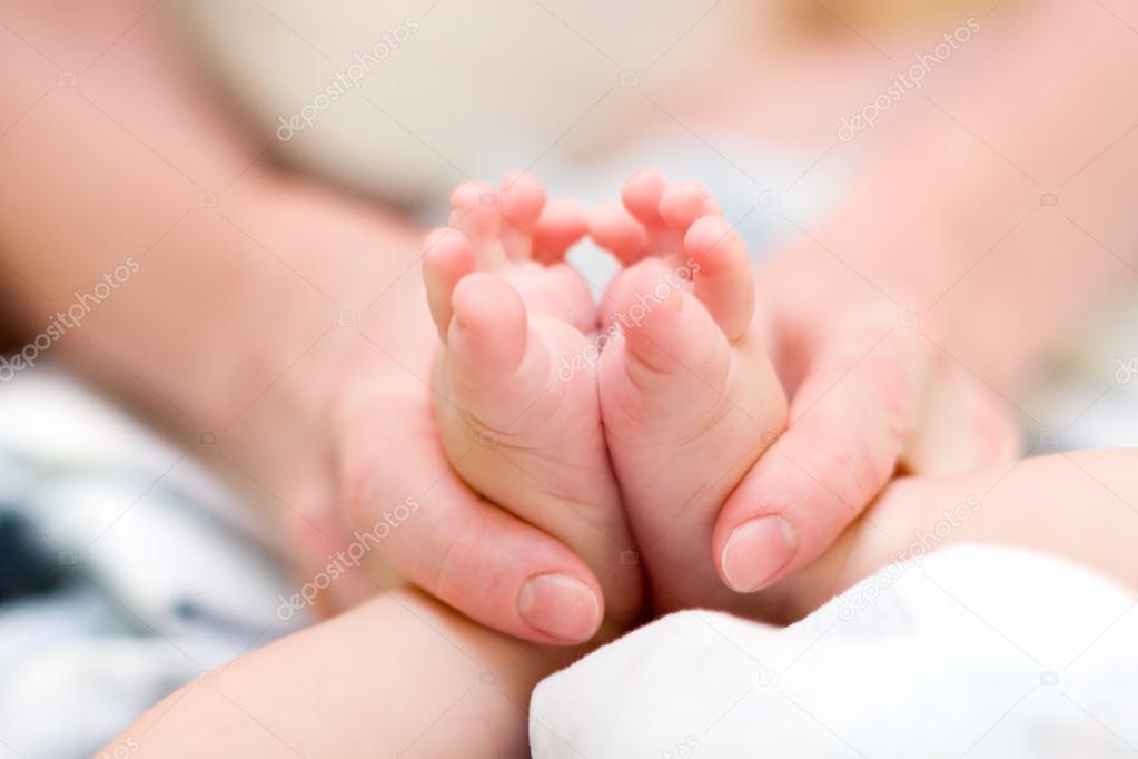 Mother gently massage baby