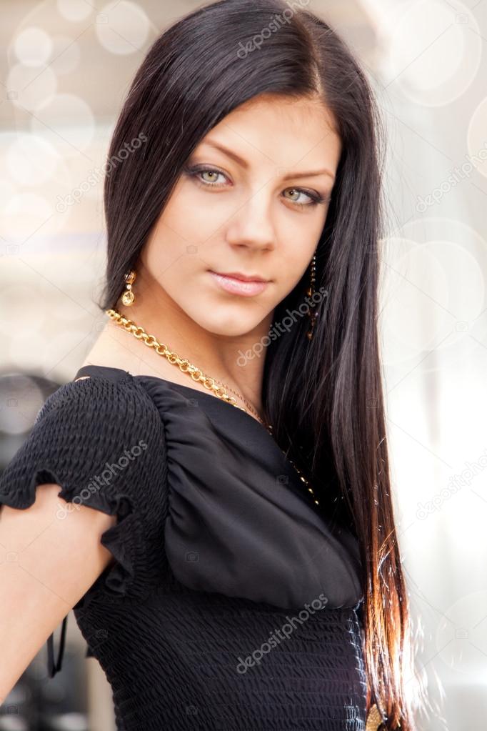 Beauty portrait of long haired smiling young brunette woman