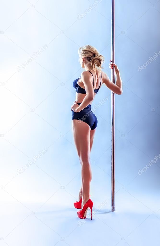 Beautiful blonde sexy pole dance woman