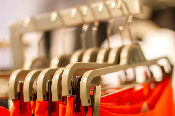 Red skirt hanging on a hanger in the store — Stock Photo, Image