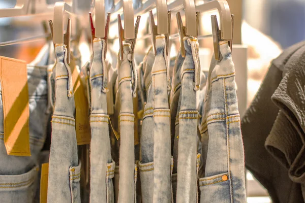 Preview jeans hanging on a hanger in the store — Stock Photo, Image