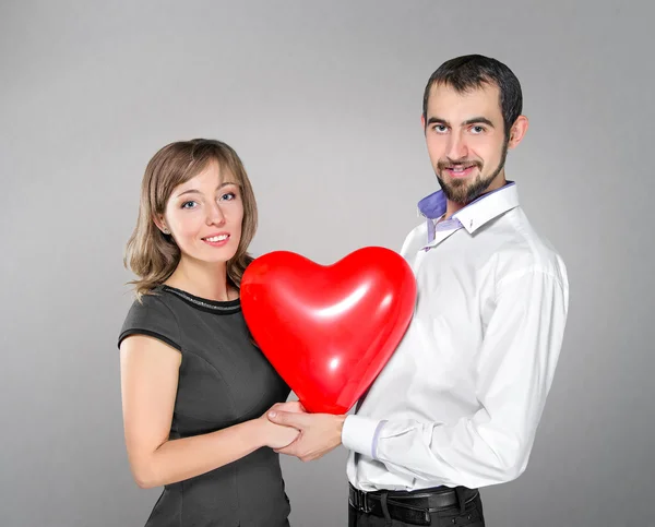 Couple with heart balloon between them — Stock Photo, Image