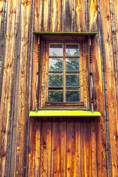 Carved frame and window in the old wooden house — Stock Photo, Image