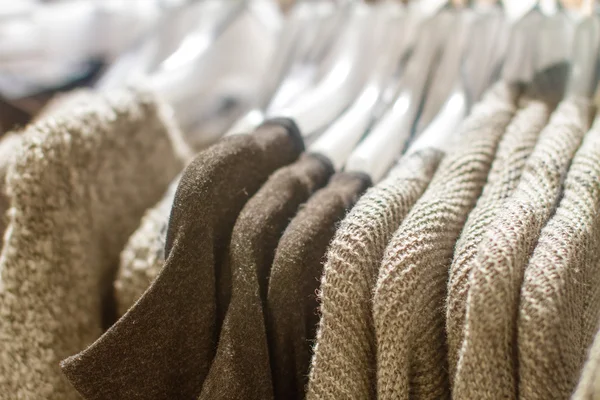 Gray sweater hanging on a hanger in the store — Stock Photo, Image