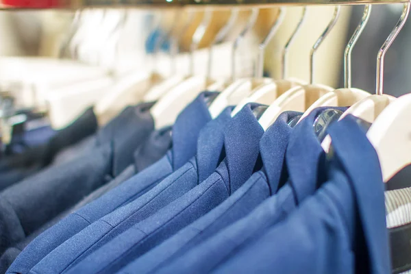 Stylish jackets hanging on the rack in the storec — Stock Photo, Image