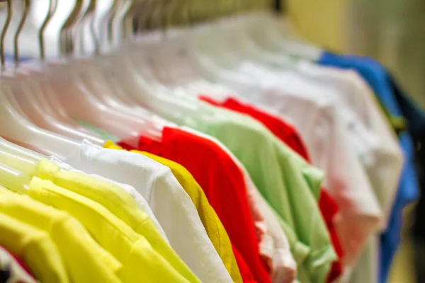 Women's shirts hanging on a hanger in the storec — Stock Photo, Image