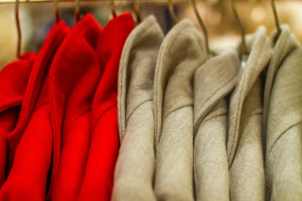 Female coat hangs on a hanger in the store — Stock Photo, Image