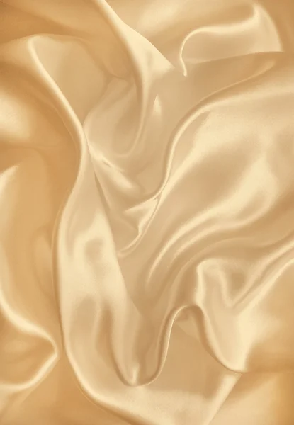 Гладкий элегантный золотой шелк или атласная текстура в качестве фона. In Se — стоковое фото