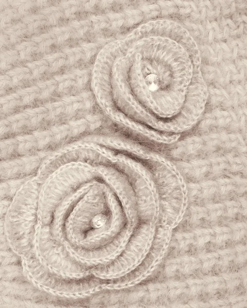 Brown wool flowers on brown wool knitted as background — Stock Photo, Image