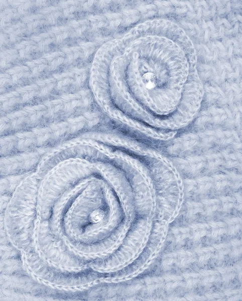 Grey wool flowers on grey wool knitted as background — Stock Photo, Image