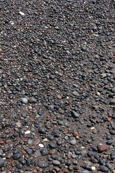 Runde meersteine am strand der insel santorini als abstrakte ba — Stockfoto