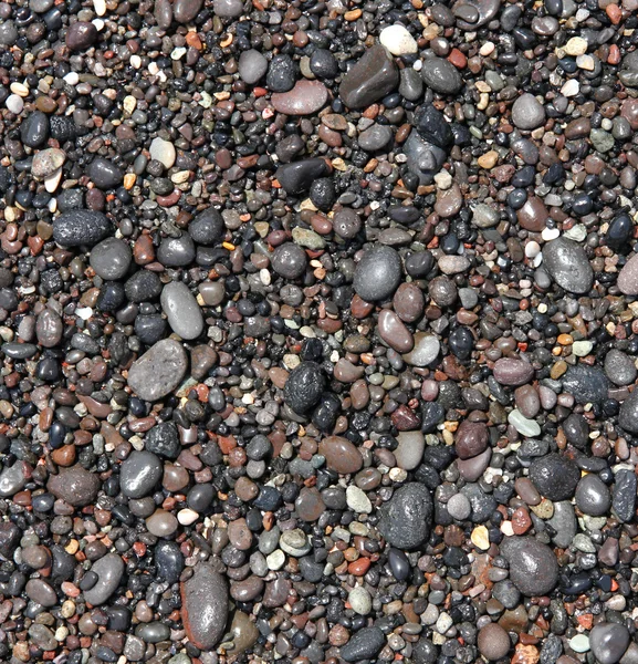 Runde meersteine am strand der insel santorini als abstrakte ba — Stockfoto