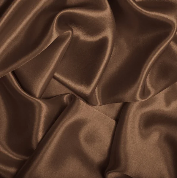 Glatte, elegante braune Seide oder Satin als Hintergrund. in Sepia getönt — Stockfoto