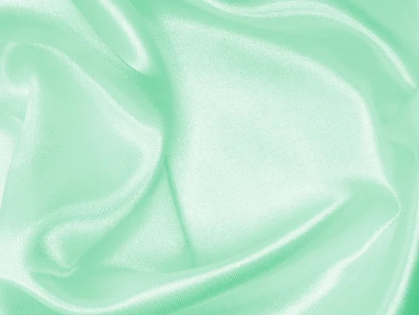 Sima, elegáns, zöld selyem vagy szatén a textúra a háttér — Stock Fotó