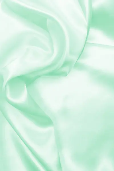 Hladké elegantní zelené hedvábí nebo satén textury pozadí — Stock fotografie