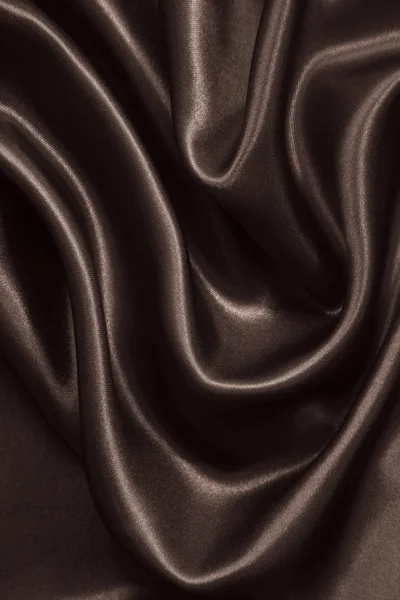 Gładkie brązowy elegancki jedwabiu lub satyny jako tło. W tonacji sepii — Zdjęcie stockowe