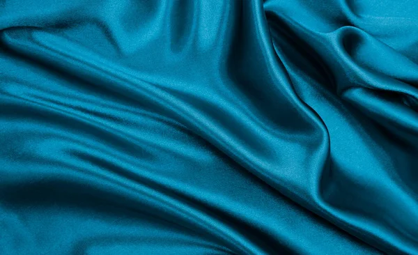 光滑典雅的蓝色丝绸或缎子的奢侈品面料可以用作抽象的背景 豪华背景设计 — 图库照片