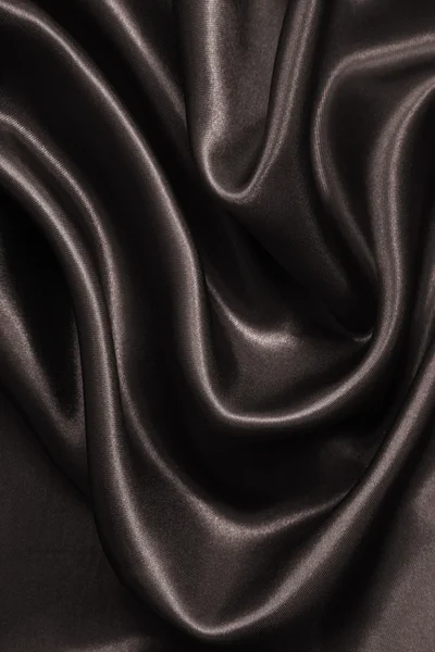 Gładkie brązowy elegancki jedwabiu lub satyny jako tło. W tonacji sepii — Zdjęcie stockowe