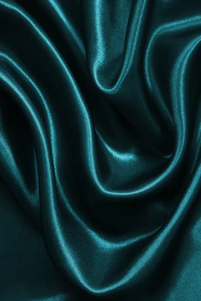 Гладкий элегантный синий шелк или атлас в качестве фона — стоковое фото