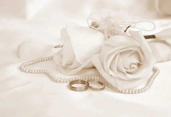 Wedding rings and roses. In Sepia toned. Retro style Stock Picture