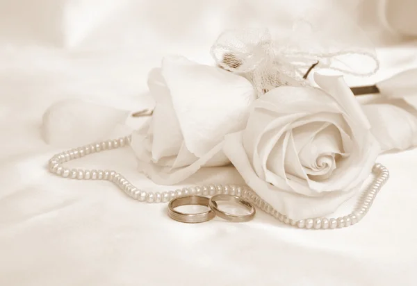 Wedding rings and roses. In Sepia toned. Retro style Royalty Free Stock Photos