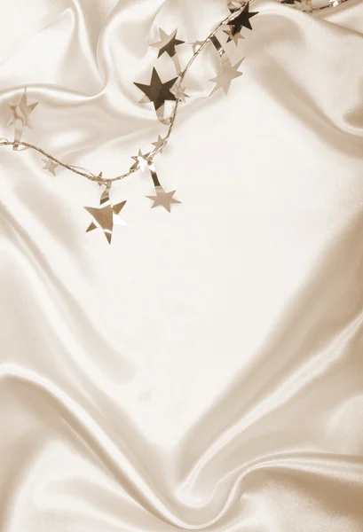 Golden stars and spangles on silk as background. In Sepia toned