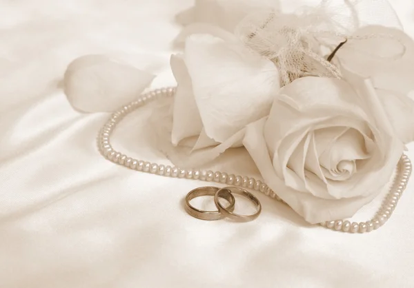 Wedding rings and roses. In Sepia toned. Retro style Stock Image