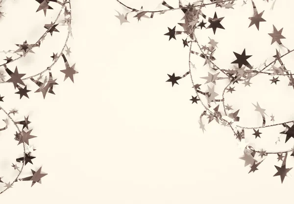 Golden stars and spangles as holiday background. In Sepia toned. — Stock Photo, Image