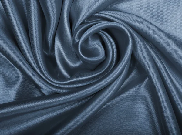 Гладкий элегантный серый шелк или атлас в качестве фона — стоковое фото