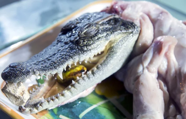 At the Asian fish market selling crocodile fillet — Stock Photo, Image