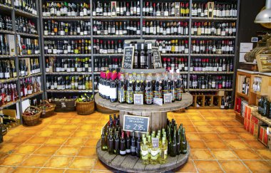 İspanya, Barselona, Mart 2021: Barcelona, İspanya 'daki La Boqueria pazarındaki çeşitli üzüm bağlarından çeşitli şaraplarla dolu raflar. Alkol, alkol ve perakende kavramı.