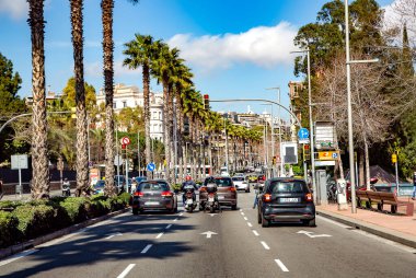 Spain, Barcelona, March, 2021: Transport traffic on the Diagonal avenue with good urban greening in Barcelona, Spain clipart
