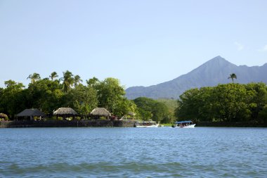 Lake Nicaragua on a background an active volcano Concepcion clipart