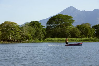Lake Nicaragua on a background an active volcano Concepcion clipart
