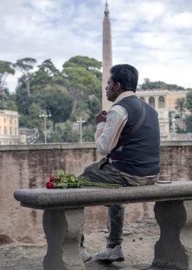 Latin man in expectations of rendezvous on Piazza del Popolo