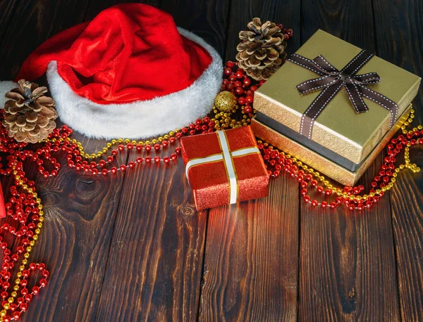 圣诞期间 圣诞桌上放有珠宝 玩具和圣诞老人帽的礼品盒 — 图库照片