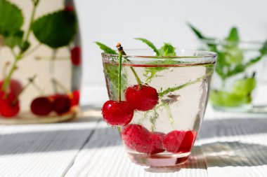 Taze taze, sulu kiraz meyveleri beyaz ahşap masada.