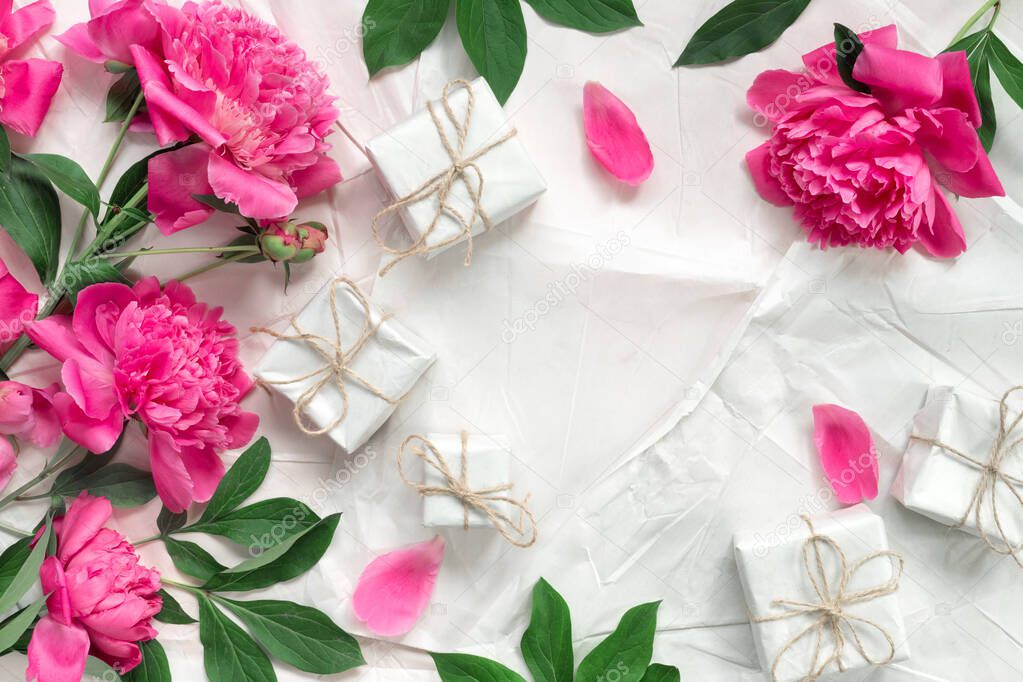 Beautiful delicate pink peonies on the background of vintage wrapping paper. Minimal concept backdrop. Template packaging paper for text. Conceptual spring banner.