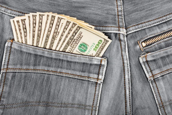 Stu dolarowe kłucie w tylnej kieszeni denim blac — Zdjęcie stockowe