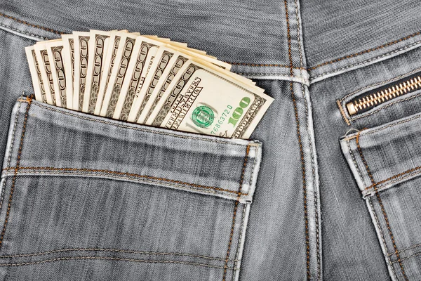 A hundred dollar bills sticking in the back pocket of denim blac — Stock Photo, Image