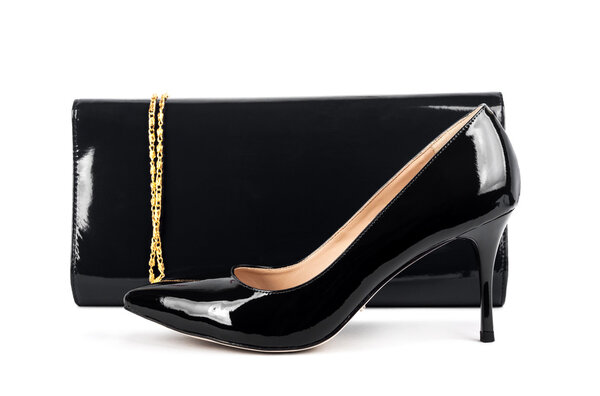 Beautiful  black shoes with clutches on white isolated backgroun