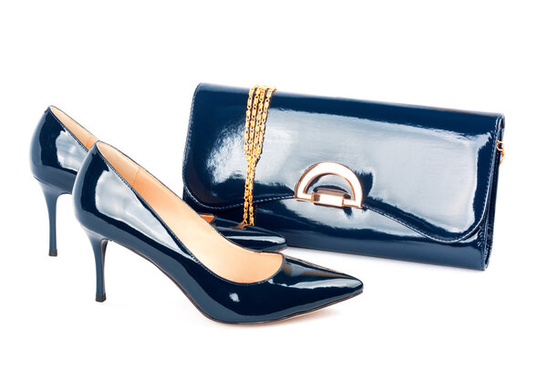 Beautiful blue shoes with clutches on white isolated background